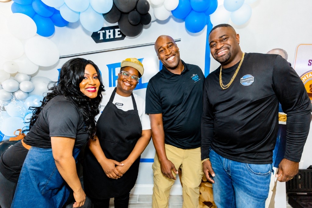 The four Anderson siblings smiling together at an Arble Baking Company event