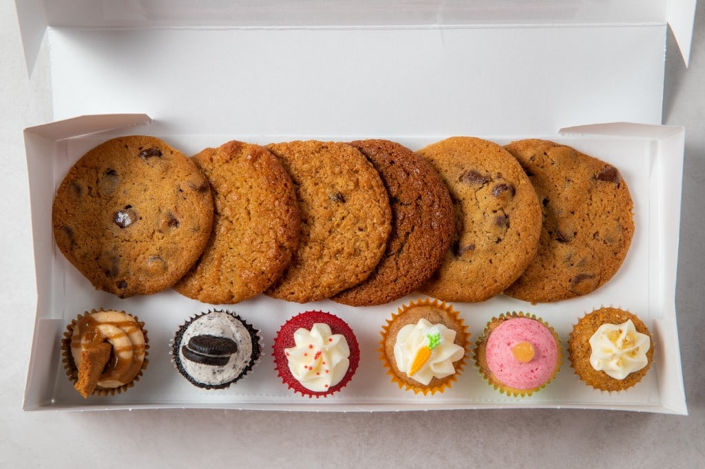 An Arble bakery box with six cookies and six assorted mini cupcakes
