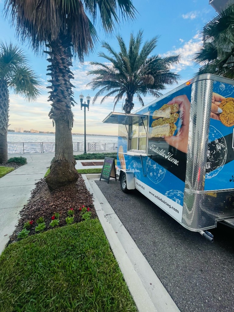 The blue Arble Baking Company food truck parked along the Jacksonville riverfront