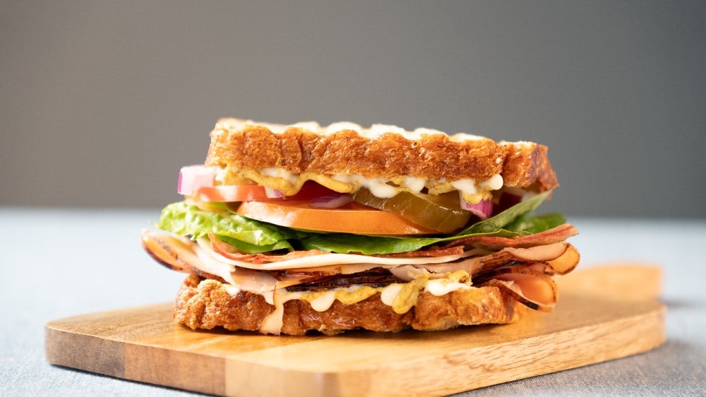 The Arble Classic sandwich stacked with deli meat, lettuce, tomato, and onion